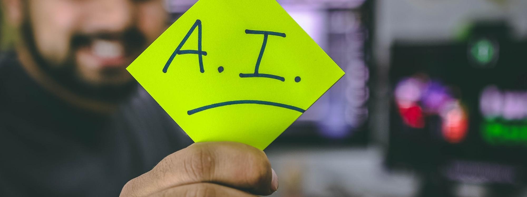 Man holding a post-it-note that says AI