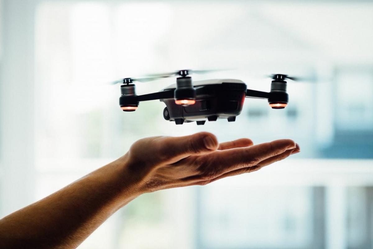 A drone hovering over a hand